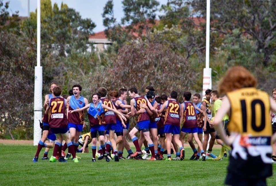 Swan View players celebrating in front of the goalposts