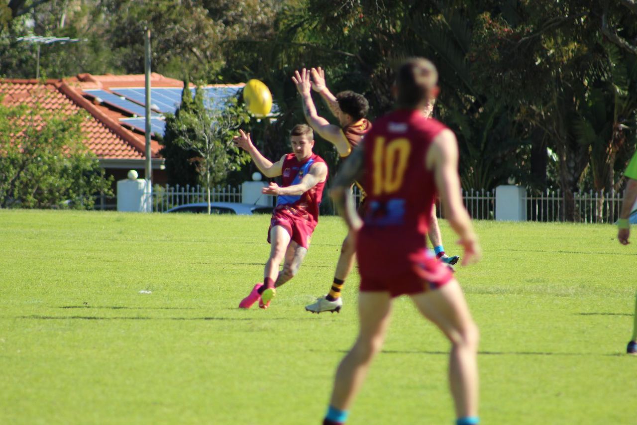 A Swan View senior player kicking the football