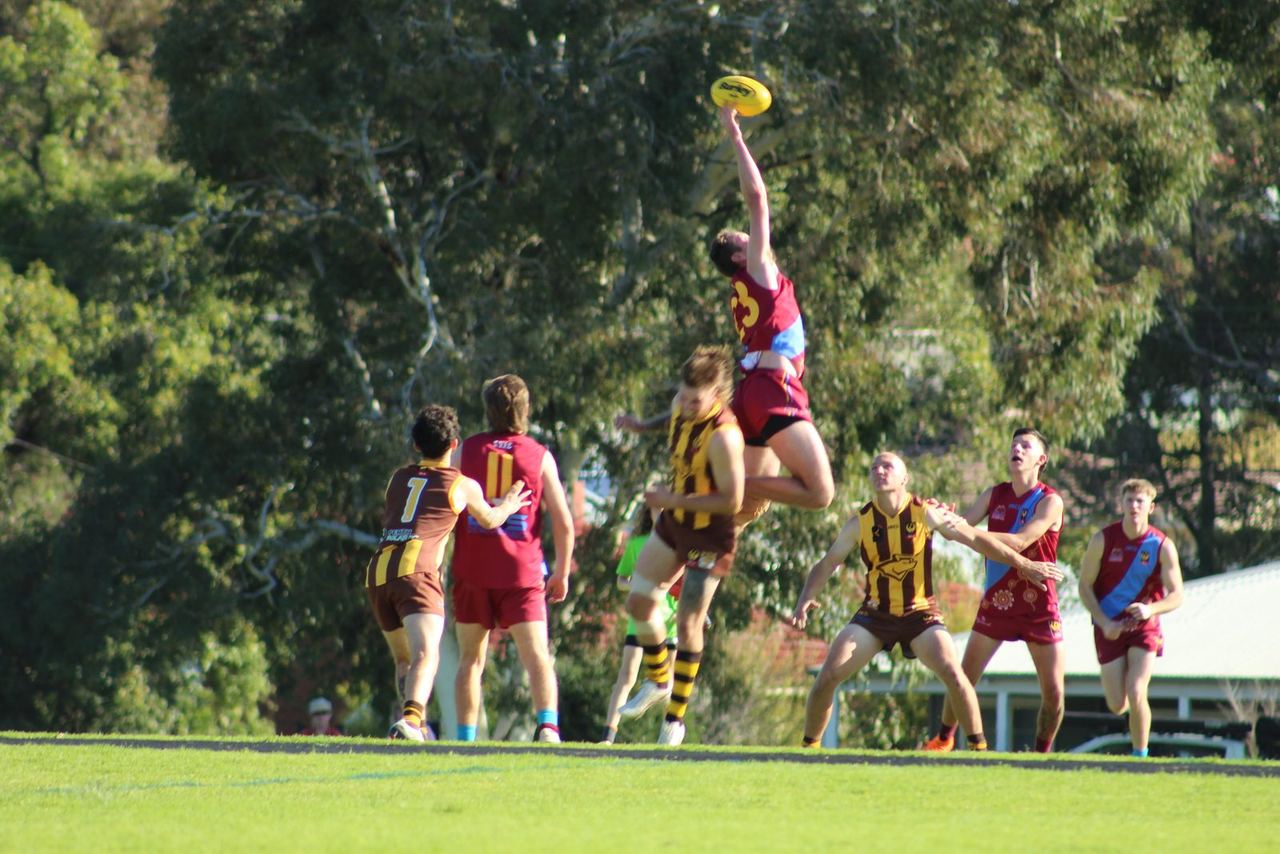 A Swan View senior player leaping for a mark in a match