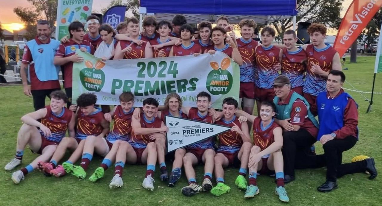 Junior team holding a 2024 Premiers banner